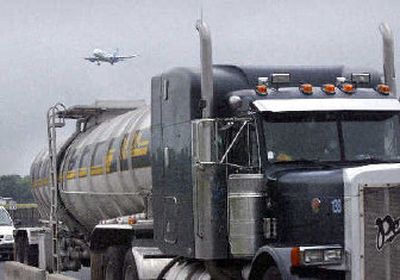 
An 8,000-gallon fuel tanker truck arrives for delivery with a plane landing in the background at Dulles International Airport on Tuesday. Supply bottlenecks have increased the risk of shortages at some of the busiest airports in the country. 
 (Associated Press / The Spokesman-Review)