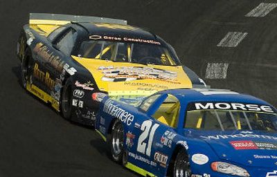 
Kevin Richards, in the number 14 Monte Carlo SS, left, drafts behind Jack Morse's number 21 car in the fourth turn in the first half of the Idaho 200.
 (Joe Barrentine / The Spokesman-Review)