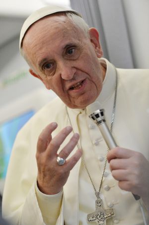 Pope Francis answers questions during a news conference Monday on the journey back from Brazil. (Associated Press)
