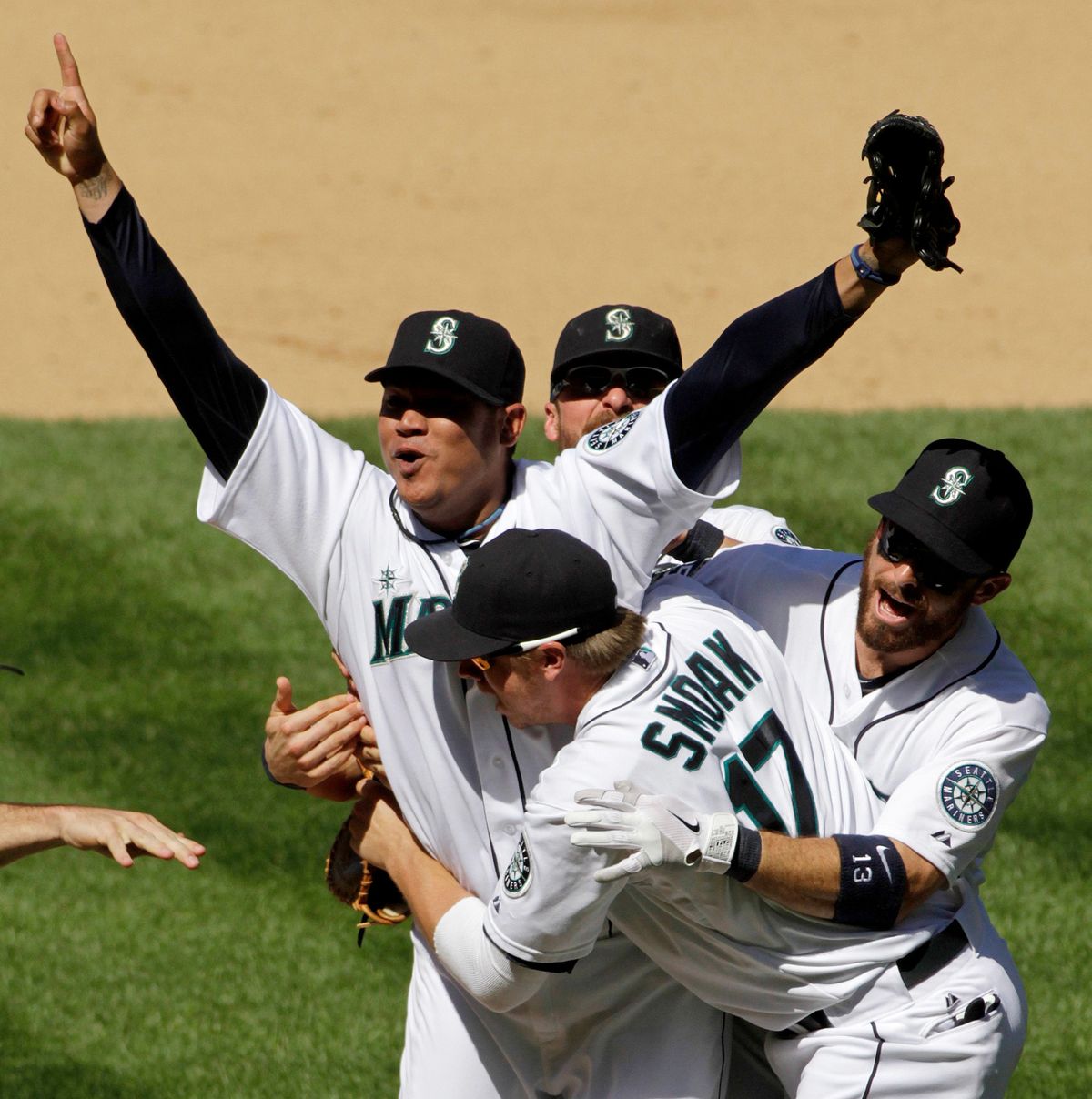 Seattle Mariners’ Felix Hernandez celebrates with teammates after pitching a perfect game against the Tampa Bay Rays on  (Seattle Times)