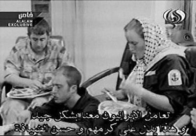 
 An unidentified British sailor, right, and an unidentified marine, among personnel seized by Iran, eat a meal in this image taken from a TV  broadcast  in Tehran on Wednesday.
 (Associated Press / The Spokesman-Review)
