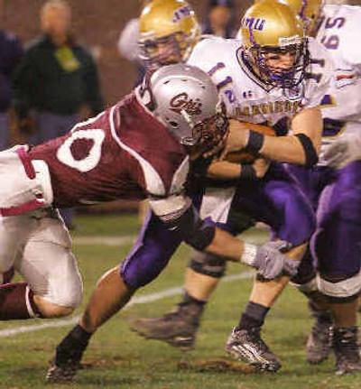 
Montana's Mike Murphy sacks Dukes QB Justin Rascati in the first quarter. 
 (Associated Press / The Spokesman-Review)