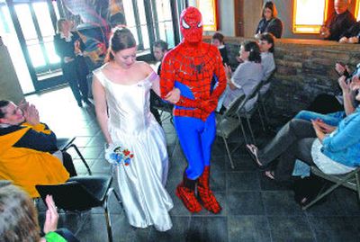 
As friends and theater workers applaud, Lindsey Bartholomew and her new husband, Robert  Kierna, walk down the aisle at the end of their wedding Friday. The two self-described movie buffs held their wedding in the lobby of the Regal Cinemas, then went to see 
