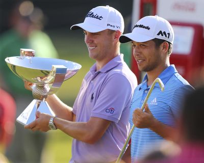 In this Sept. 24, 2017 file photo, Justin Thomas, left, holds the trophy after winning the Fedex Cup, as he stands with Xander Schauffele who holds the trophy after winning the Tour Championship golf tournament at East Lake Golf Club in Atlanta. (Curtis Compton / Atlanta Journal-Constitution via AP)