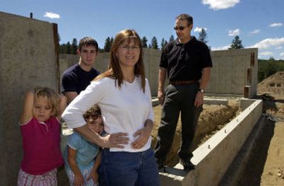 
 Dennis and Sherry Paul visit their home under construction near Liberty Lake with their son,  Devan, 17, and adopted girls Shelby, left, and Ashley, both 4. The Pauls' foster care license was revoked because they moved into an apartment while the home is being built. 
 (Dan Pelle / The Spokesman-Review)