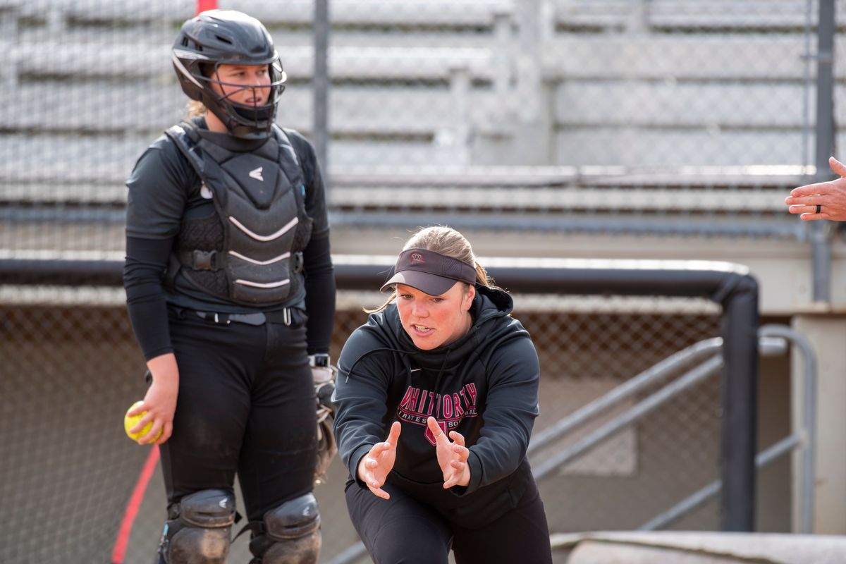 Whitworth’s Maddy Thomas, who said she may want to coach someday, gives a quick lesson on where the catcher should be in the box during practice Wednesday.  (Jesse Tinsley/THE SPOKESMAN-REVI)
