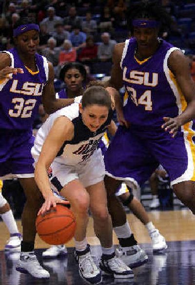 
Connecticut's Mel Thomas, surrounded by LSU players, gathers in a loose ball.
 (Associated Press / The Spokesman-Review)
