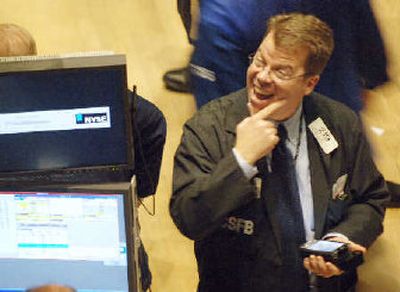
James Burgen, of Credit Suisse, monitors trades early in the trading day on Monday as the Dow Jones industrial average passed the 11,000 mark.
 (Associated Press / The Spokesman-Review)