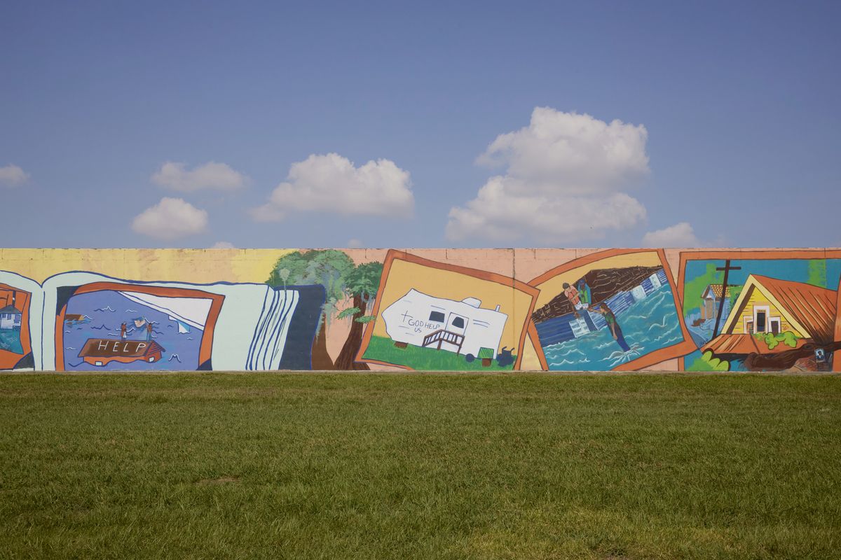 A mural at the site of a levee that breached during Katrina, created by young students based on what they learned about the hurricane during a community organization’s summer program, in New Orleans, Aug. 28, 2025. The city has taken pride in its ability to endure, but 20 years on from Hurricane Katrina, many residents are fed up with dysfunction and soaring costs, and want it to strive for more.   (Annie Flanagan/The New York Times)
