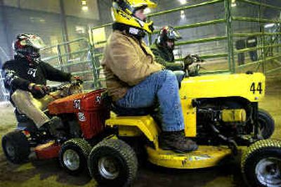 Brian Warnecke, Dave Covey and John Dow of the Okanogan Valley Lawnmower Racing Association wait for the signal to race their lawnmowers at the Spokane Fair and Expo Center Saturday afternoon.
(Holly Pickett / The Spokesman-Review)
