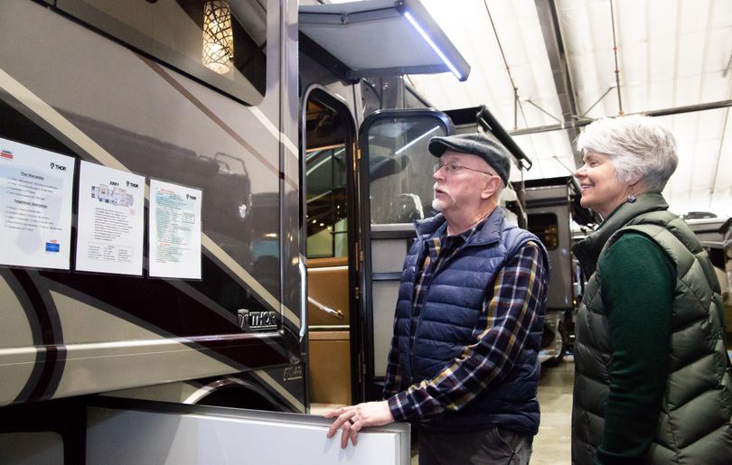 Amy and Dan Heinen look at the specs of a $229,000 Thor Motor Coach, dealt by RNR RV Center, on Jan. 26, 2020, during the 2020 Inland Northwest RV Show and Sale at the Spokane County Fair and Expo Center in Spokane Valley, Wash. Sunday was the last day of the 2020 show, which has run annually for 32 years. (Libby Kamrowski / The Spokesman-Review)