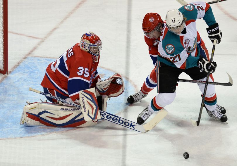 Ryan Olsen (27) of the Kelowna Rockets attacks Spokane Chiefs' goalie Eric Williams while closely followed by Spokane's defender Tyler King in the first period Tuesday, Oct. 8, 2013 at the Spokane Arena. After two periods, the Chiefs led 5-2. (Jesse Tinsley / The Spokesman-Review)