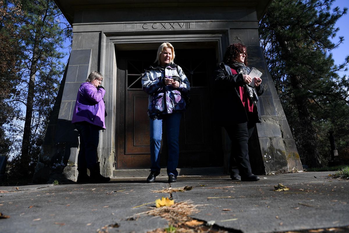 Kika Morelan, a paranormal investigator with Spokane Paranormal Investigation Group, center, and Ghost 411 podcast hosts Jane Stewart, left, and Stacy Moore, right, search for spirits to communicate with during a psychic reading on Saturday, Oct. 26, 2019, at Greenwood Memorial Terrace in Spokane, Wash. The psychic reading was pat of an Halloween episode for the Ghost 411 podcast. (Tyler Tjomsland / The Spokesman-Review)
