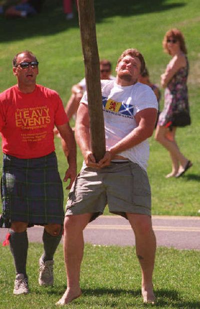 
Ken Buchanan puts all his strength into the Caber Toss at the Spokane Highland Games. The pole weighs 80 lbs and is 18 feet long. 
 (File photos/ / The Spokesman-Review)