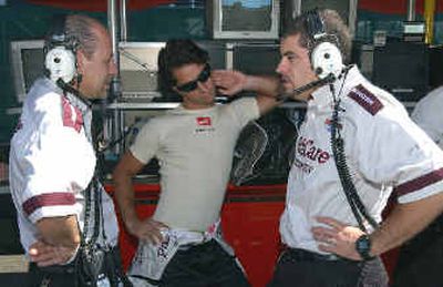 
Bruno Junqueira, center, talks strategy with pit members on Friday. 
 (Associated Press / The Spokesman-Review)