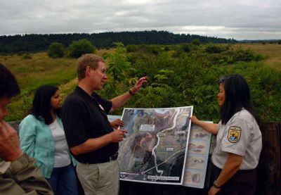
Overlooking the Nisqually Delta area near Olympia, Tom Dwyer, from the Ducks Unlimited conservation group, discusses the next phase of estuary restoration work with refuge manager Jean Takekawa during a tour Wednesday. 
 (Associated Press / The Spokesman-Review)