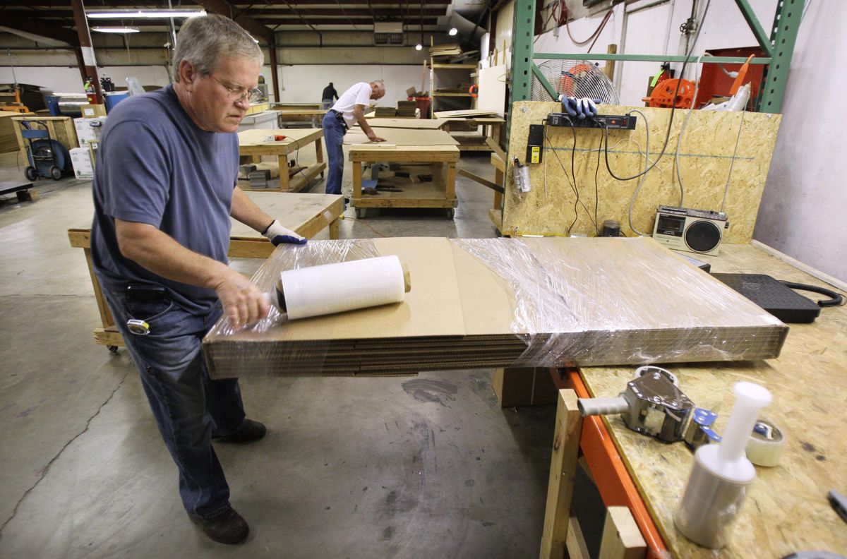 Box maker Terry Arnold wraps a stack of boxes to be shipped at Custom Made Boxes in Des Moines, Iowa. The company absorbed most of an 11.5 percent increase in the price of containerboard, which is what cardboard boxes are made of, choosing not to pass along the full amount to retailers who use boxes. Associated Press photos (Associated Press photos / The Spokesman-Review)