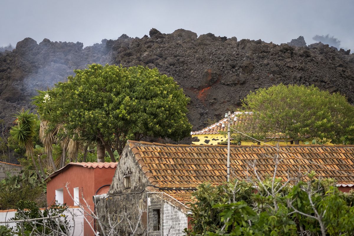 Lava from a volcano eruption flows on the island of La Palma in the Canaries, Spain, Wednesday, Sept. 22, 2021. The volcano on a small Spanish island in the Atlantic Ocean erupted on Sunday, forcing the evacuation of thousands of people. Experts say the volcanic eruption and its aftermath on a Spanish island could last for up to 84 days. The Canary Island Volcanology Institute said Wednesday it based its calculation on the length of previous eruptions on the archipelago.  (Emilio Morenatti)