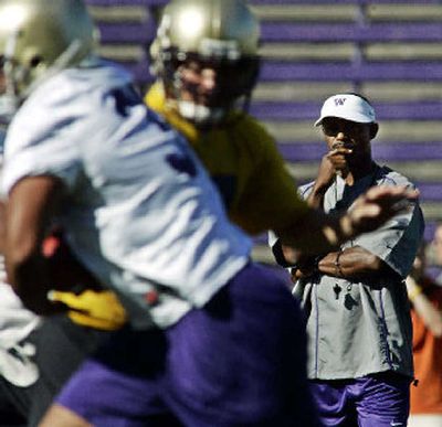 
University of Washington head football coach Tyrone Willingham, right, watches players taking part in an offensive drill.
 (Associated Press / The Spokesman-Review)