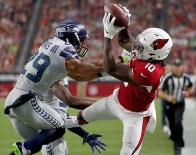 Arizona Cardinals wide receiver Chad Williams makes the catch as Seattle Seahawks defensive back Earl Thomas defends during the first half on Sunday in Glendale, Arizona. (Rick Scuteri / AP)