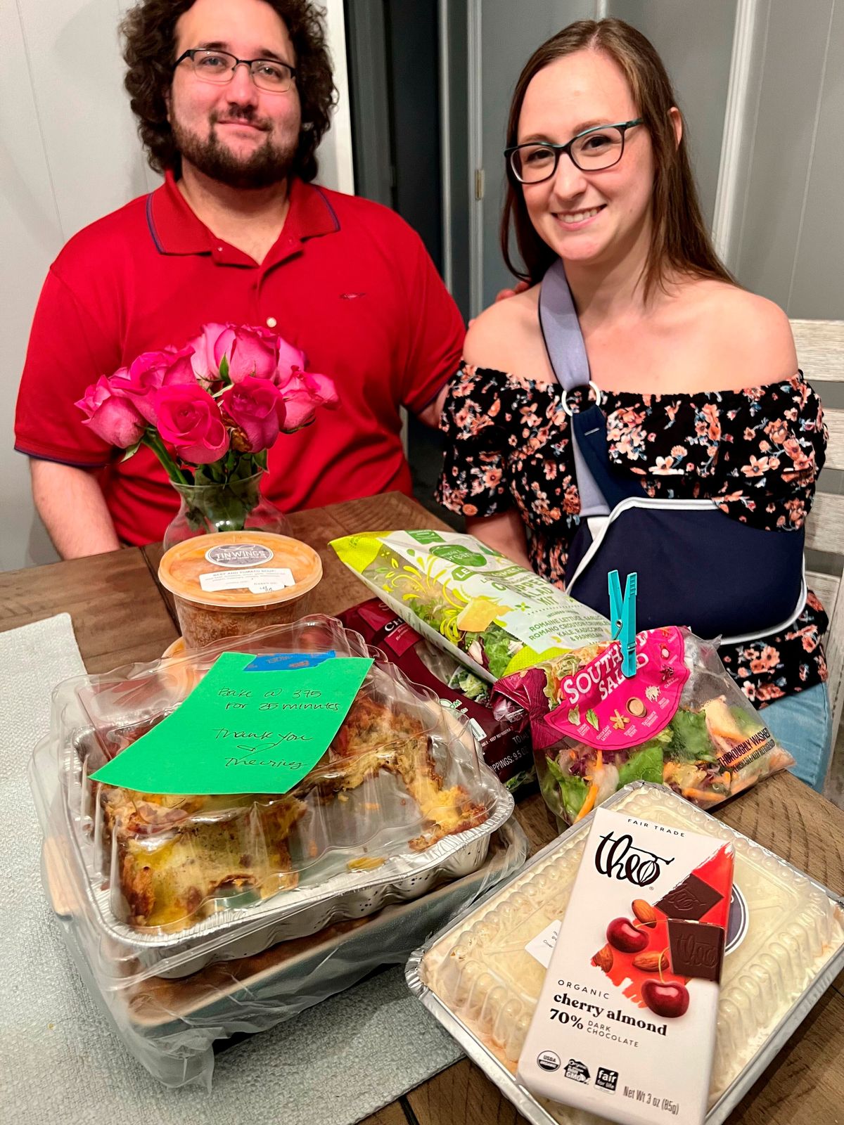 Rachel and Michael Davis pose May 22, 2022, in their Hendersonville, Tenn., home, with flowers, food and notes they've received from teachers and parents. On May 11, Rachel Davis tackled an intruder to stop him from reaching students at her Inglewood Elementary School, resulting in her breaking her arm.  (Brad Schmitt)
