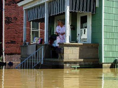 
Lynn Walton fishes from her porch in Wheeling, W.Va., on Sunday. 
 (Associated Press / The Spokesman-Review)