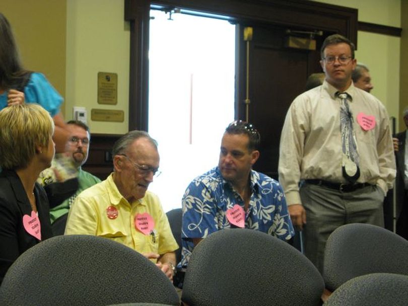 Phil Hart supporters at the House Ethics Committee hearing are wearing pink paper hearts saying 'Protect Idaho's Hart.' (Betsy Russell)