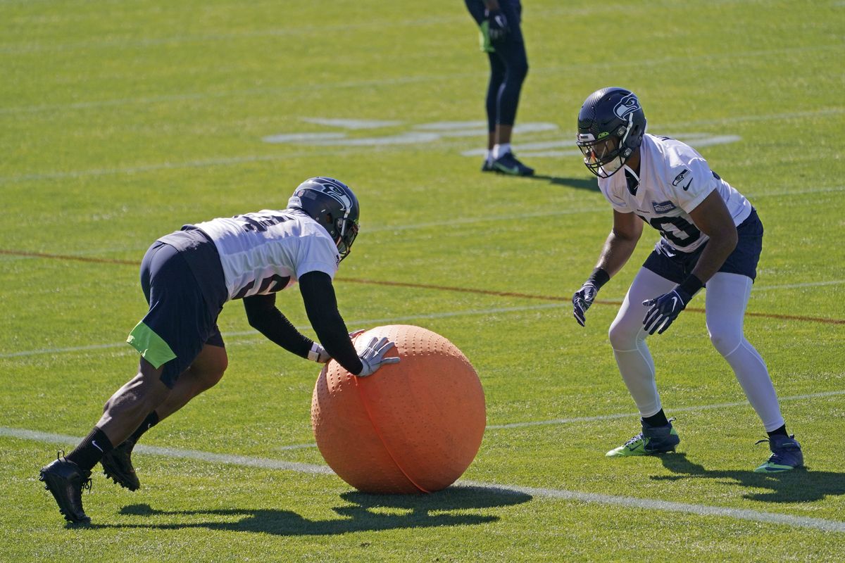 Seattle Seahawks linebacker Bobby Wagner, left, rolls a weighted ball with linebacker K.J. Wright, right, during NFL football training camp Tuesday, Sept. 1, 2020, in Renton, Wash.  (Associated Press)