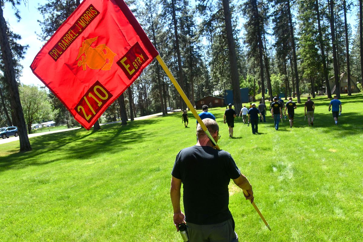 U.S. Army veterans Jim Steiner carries a guidon honoring fallen U.S.Marine Cpl. Darrel J. Morris during the Modern Day Warrior Retreat, Friday, June 4, 2021 at Pinelow Park in Deer Lake.  (DAN PELLE/THE SPOKESMAN-REVIEW)