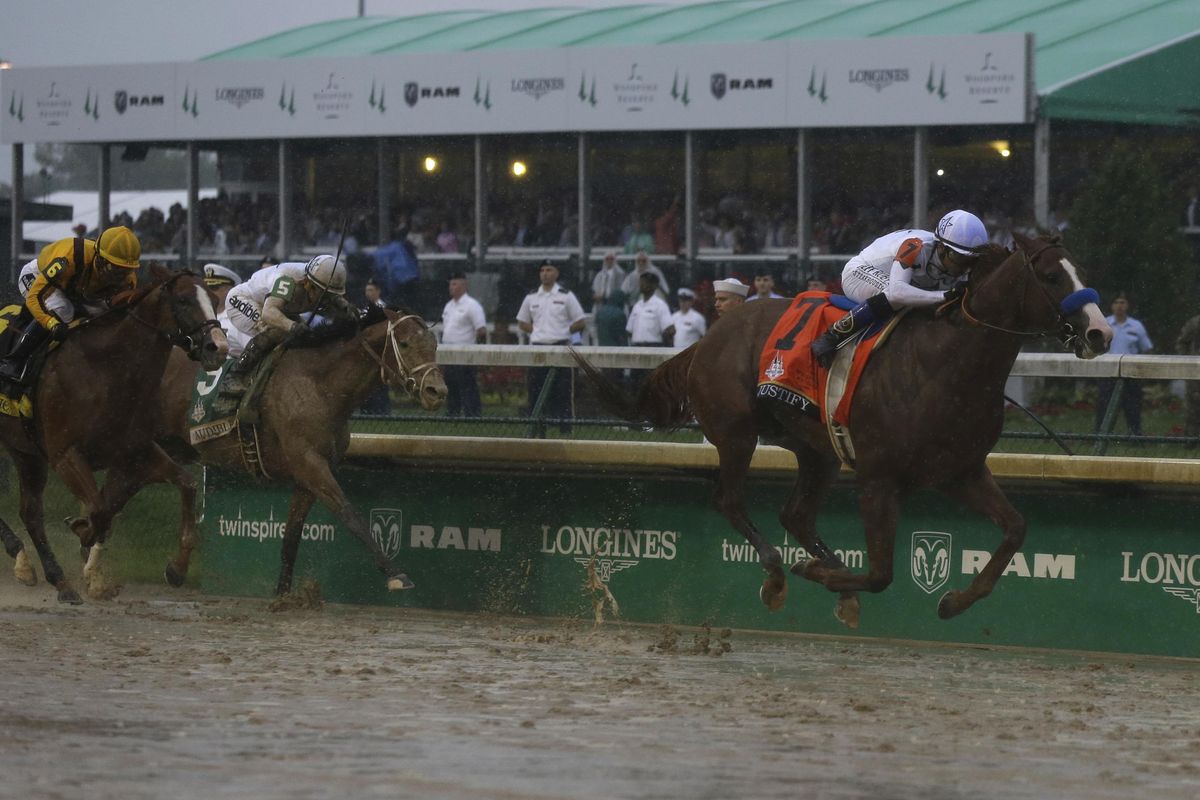 Mike Smith rides Justify to victory in the 144th running of the Kentucky Derby on Saturday at at Churchill Downs in Louisville, Ky. (Kiichiro Sato / Associated Press)
