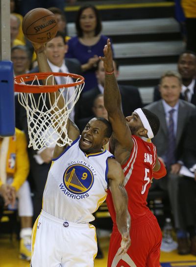 Warriors’ Andre Iguodala beats Rockets’ Josh Smith to the basket in the first half Wednesday. (Associated Press)