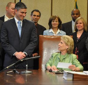 Gov. Chris Gregoire and Sen. Mike Baumgartner, R-Spokane, talk June 15, 2011 before the signing of his bill to consolidate some state agencies.  (Jim Camden/The Spokesman-Review)