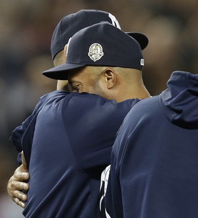 Yankees reliever Mariano Rivera, right, embraces teammate Andy Pettitte, who came out to the mound after Rivera’s final game appearance at Yankee Stadium on Thursday night. Both are retiring. (Associated Press)