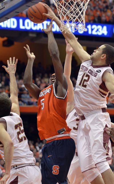 Boston College's Ryan Anderson, right, blocks a shot by Syracuse's C.J. Fair during the Eagles’ 62-59 overtime win. (Associated Press)