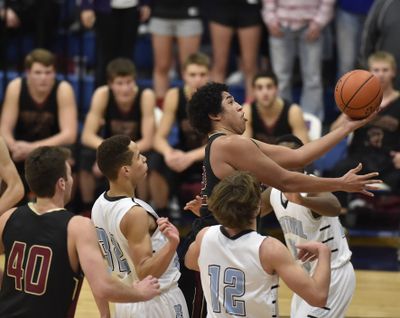 University High School’s Robert Little drives the ball against Central Valley during a high school basketball game Dec. 19 at Central Valley High School. (Tyler Tjomsland)