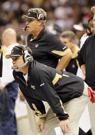 Saints coach Sean Payton, foreground, has taken responsibility for bounty program by former assistant Gregg Williams, background. (Associated Press)