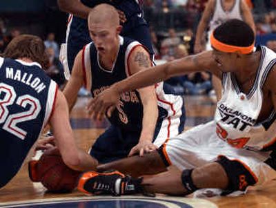 
Gonzaga players Sean Mallon, left, and Derek Raivio and Oklahoma State forward JamesOn Curry scramble for a loose ball in Tuesday's night's game in Oklahoma City.
 (Associated Press / The Spokesman-Review)