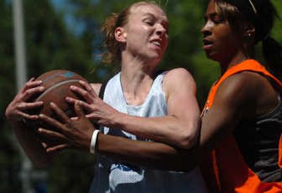 
Megan Murray, left, of Total Package, and Rain Drops' Jennifer Kennedy battle for the ball during a Hoopfest game Saturday. 
 (Ingrid Lindemann / The Spokesman-Review)