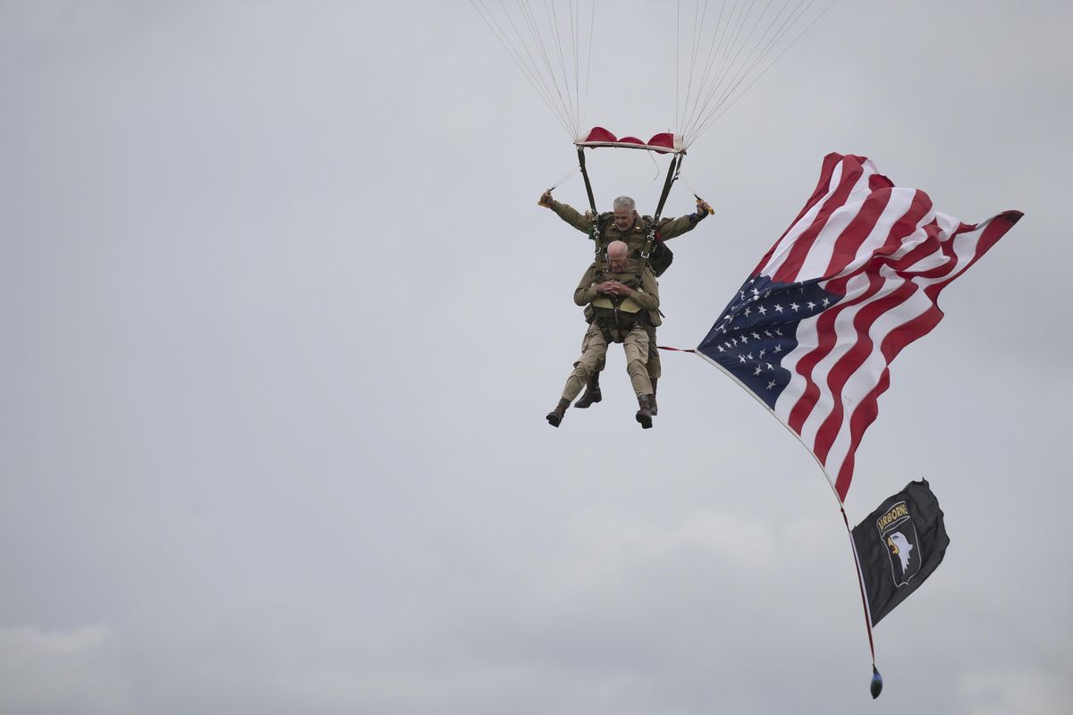 U.S. World War II D-Day veteran Tom Rice, from Coronado, CA, parachutes in a tandem jump into a field in Carentan, Normandy, France, Wednesday, June 5, 2019. Approximately 200 parachutists participated in the jump over Normandy on Wednesday, replicating a jump made by U.S. soldiers on June 6, 1944 as a prelude to the seaborne invasions on D-Day. (AP)