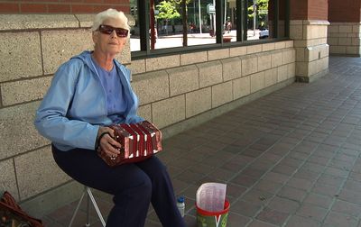 Sarah DeRyan plays her concertina Wednesday on Wall Street in downtown Spokane. DeRyan, a Street Music Week participant, said she can play 180 songs.  (Colin Mulvany / The Spokesman-Review)