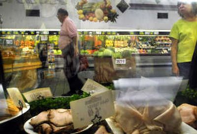 
Shoppers select groceries at a Yoke's store, 4507 W. Wellesley, on Thursday. The 30,000-square-foot store, which is about half the size of Yoke's Fresh Markets, is slated to close soon. 
 (Jed Conklin / The Spokesman-Review)
