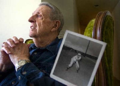 Bill Ogle, with a photograph from his playing days during World War II, reflects Wednesday on his love for baseball.
(Christopher Anderson / The Spokesman-Review)