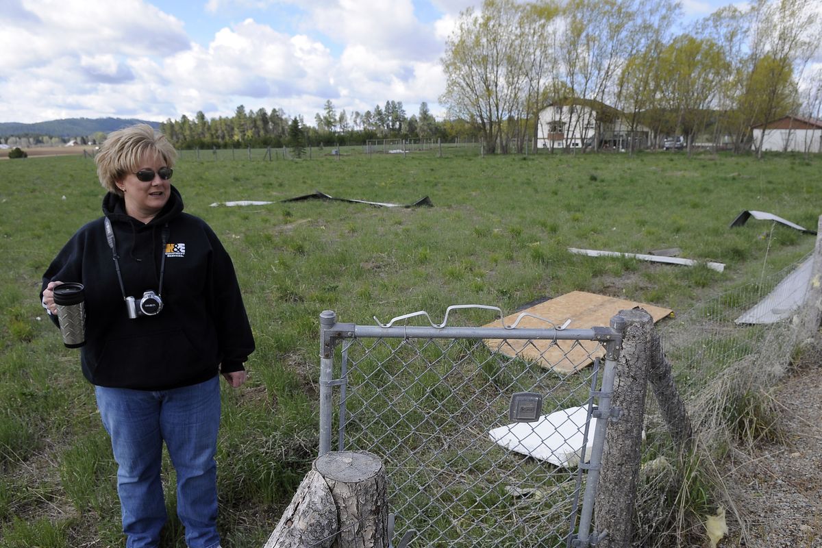 Lynn White surveys the roof debris left in a field next her damaged garage, May 7, 2009 , on Monroe near Wild Rose in Spokane County.  Strong wind ripped through the area on Wednesday evening.  DAN PELLE  The Spokesman-Review (Dan Pelle / The Spokesman-Review)