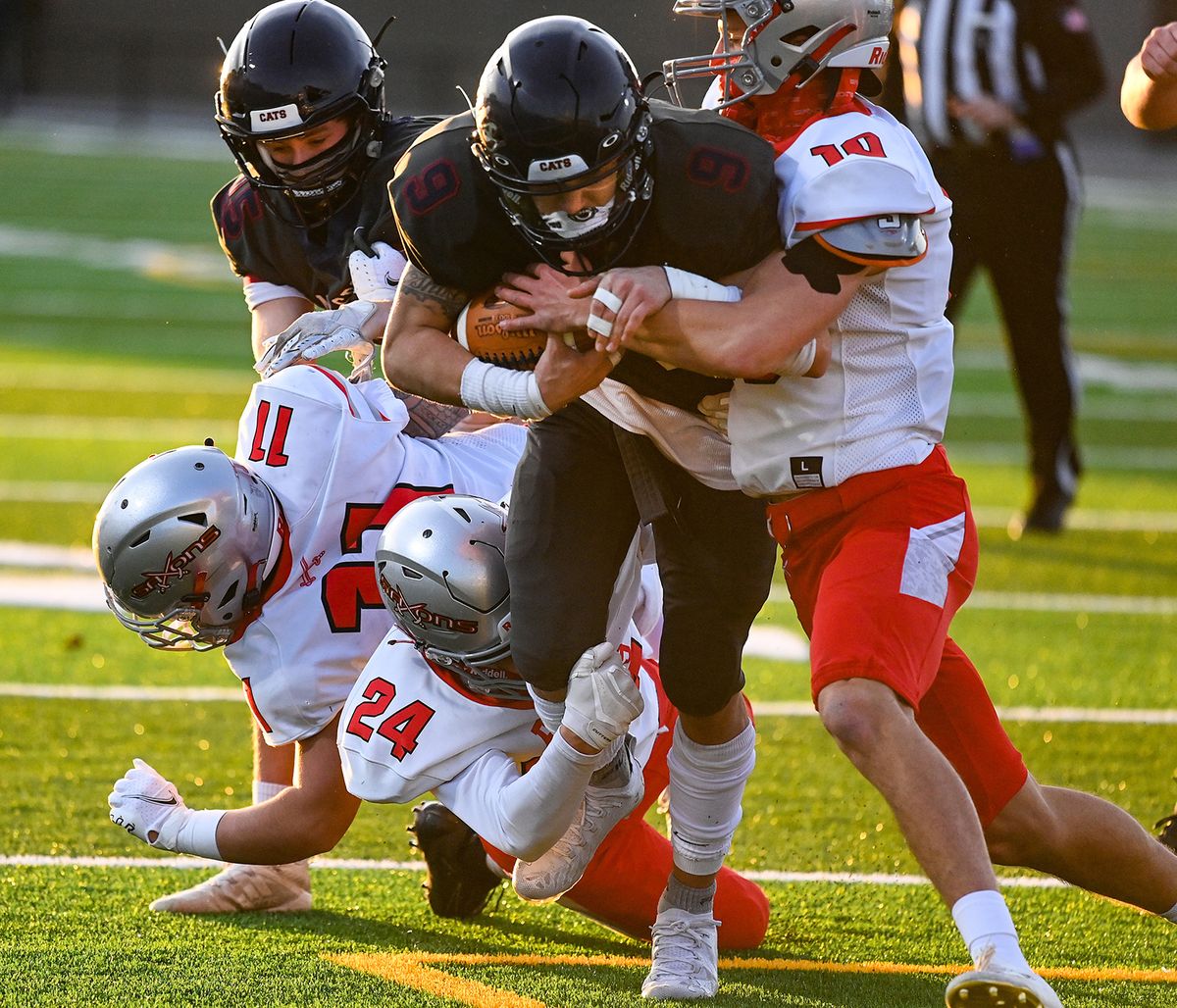 Mt. SpokaneÕs Aiden Prado (9) runs the ball as Ferris defensive back Al Newcomb (10) moves in to tackle during the first half of a GSL high school football game, Fri., March 12, 2021, at Union Stadium in Mead, Wash. (Colin Mulvany/THE SPOKESMAN-REVIEW)