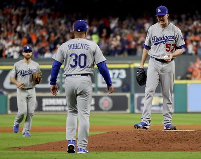 In this Oct. 18, 2017, file photo, Los Angeles Dodgers manager Dave Roberts walks out to pitcher Alex Wood during the sixth inning of Game 4 of baseball’s World Series against the Houston Astros, in Houston. Major League Baseball is imposing stricter limits on mound visits in an effort to speed games but decided against 20-second pitch clocks for 2018. The new rules announced Monday, Feb. 19, 2018, include a general limit of six mound visits per nine-inning game without a pitching change, whether by a manager, coach or player. (Matt Slocum / Associated Press)