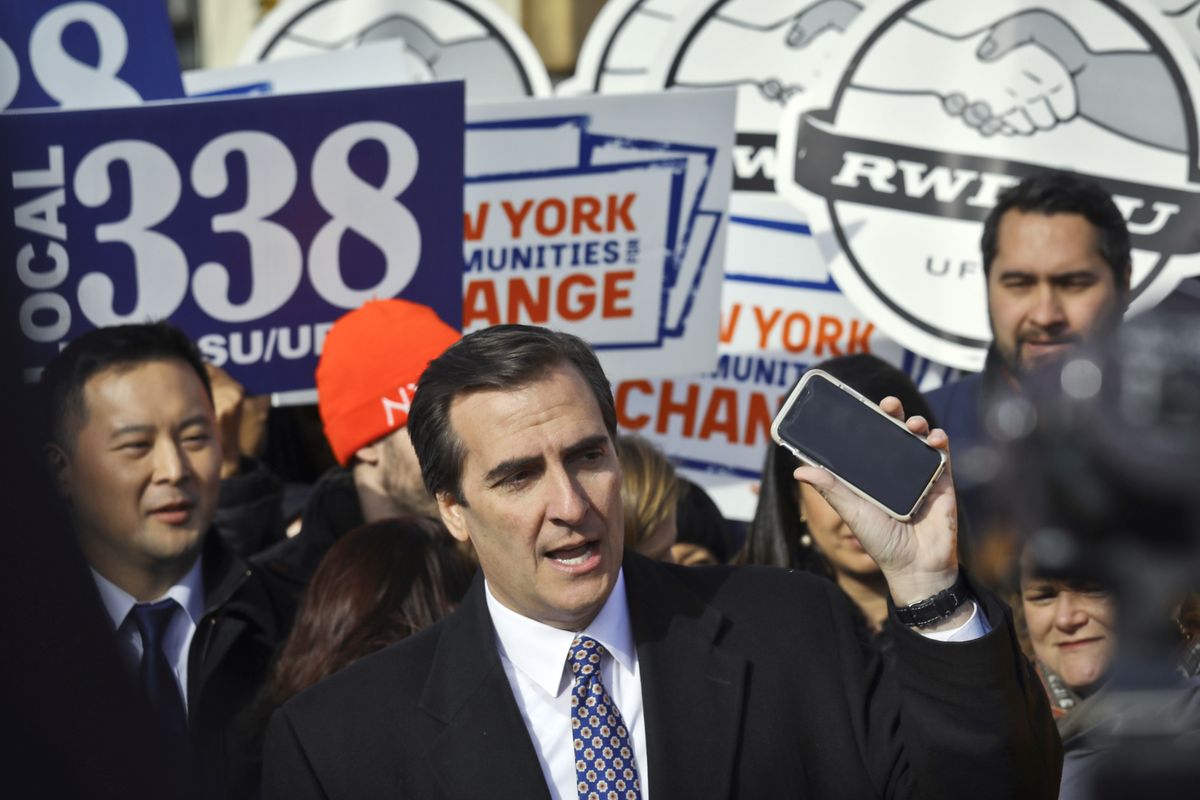 This Nov. 14, 2018 photo shows New York State Sen. Michael Gianaris, center, as he calls on supporters to remove the Amazon app from their phones and boycott the company, as he address a coalition rally and press conference, in New York. Big tech’s outsized influence over society has become one of the biggest battlefronts in state legislatures this year. Lawmakers are taking on tech and social media companies over a wide range of issues, including anti-trust, digital privacy, taxing ad sales, net neutrality and censorship.  (Bebeto Matthews)