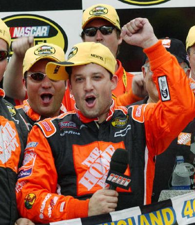
Tony Stewart celebrates in victory lane after winning the NASCAR New England 300 Sunday.
 (Associated Press / The Spokesman-Review)