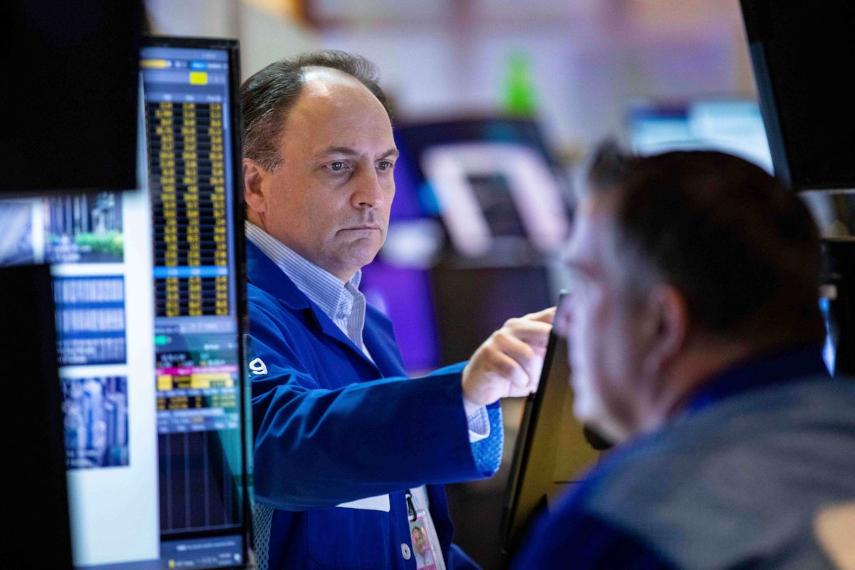 In this photo provided by the New York Stock Exchange, trader James Conti works on the floor, Thursday, April 14, 2022. Stocks wavered in morning trading on Wall Street Thursday as investors reviewed the latest economic data and corporate earnings amid lingering concerns about inflation and rising interest rates.  (Courtney Crow)