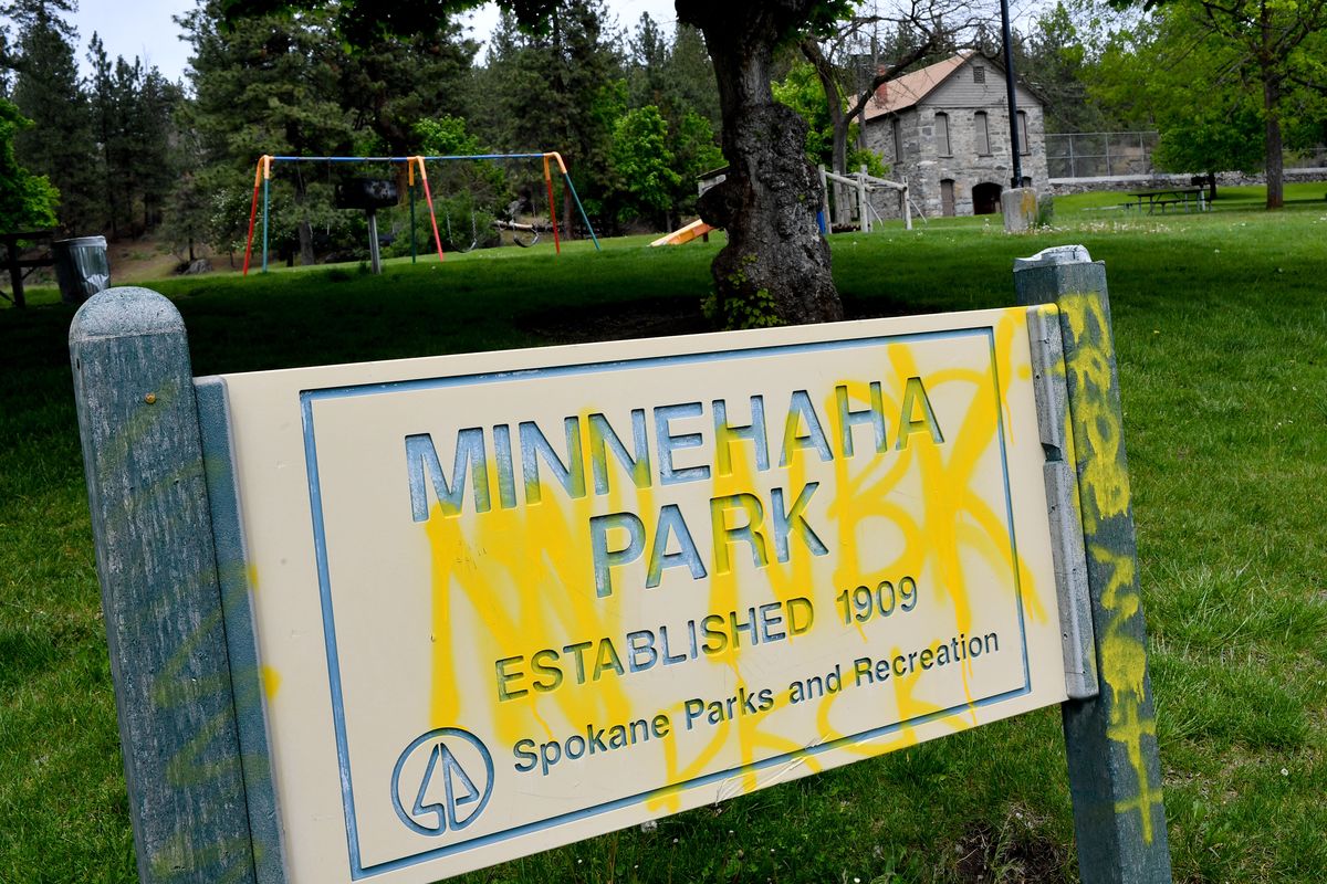 Minnehaha Park’s sign is photographed Thursday defaced with graffiti in Spokane. Upgrades to the park are being considered.  (Tyler Tjomsland/The Spokesman-Review)