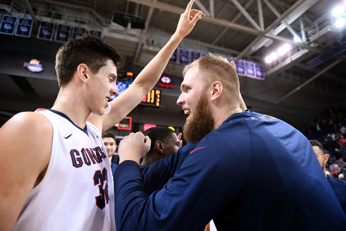 Gonzaga forward Zach Collins (32) and Gonzaga center Przemek Karnowski (24) celebrate their 93-53 win over Loyola Marymount during the second half of an NCAA college basketball game, Thurs., Jan. 12, 2017, in the McCarthey Athletic Center. (Colin Mulvany / The Spokesman-Review)